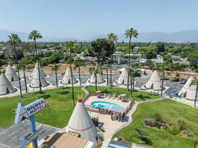 an aerial view of a resort with white umbrellas at Wigwam Motel in San Bernardino