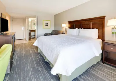 a hotel room with a large bed and a television at Hampton Inn Los Angeles/Carson in Carson