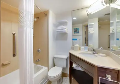 a bathroom with a toilet and a sink and a bath tub at Hampton Inn Los Angeles/Carson in Carson