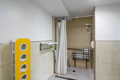 a bathroom with a shower with a shower curtain at Motel 6-Norwalk, CA in Norwalk