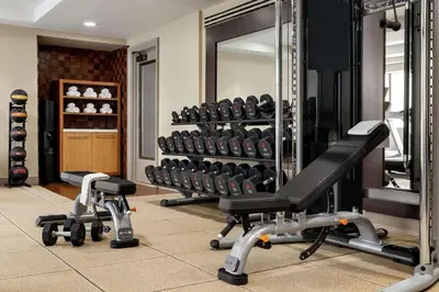 a gym with two treadmills and a mirror at Hilton Checkers Los Angeles in Los Angeles