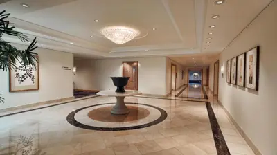 a lobby with a vase in the middle of a room at Hilton Los Angeles Airport in Los Angeles