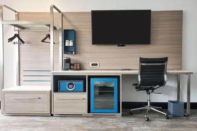 an office with a desk with a tv and a chair at Casa Via Mar Inn, an Ascend Collection Hotel in Port Hueneme