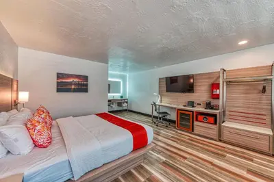 a bedroom with a bed and a desk and a television at Casa Via Mar Inn, an Ascend Collection Hotel in Port Hueneme