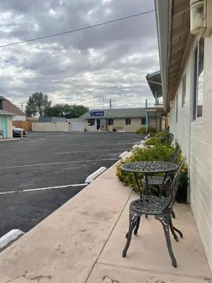 a table and chair sitting next to a parking lot at Howard Johnson by Wyndham Ridgecrest, CA in Ridgecrest