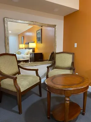 a room with two chairs and a table and a mirror at Howard Johnson by Wyndham Ridgecrest, CA in Ridgecrest