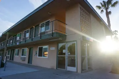 a building with a balcony on the side of it at Americas Best Value Inn Thousand Oaks in Thousand Oaks