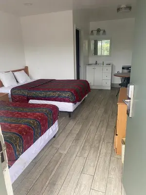 a hotel room with two beds and a kitchen at Americas Best Value Inn Thousand Oaks in Thousand Oaks