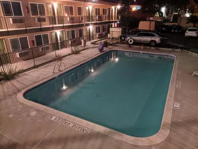 a swimming pool in front of a building at night at Americas Best Value Inn Thousand Oaks in Thousand Oaks