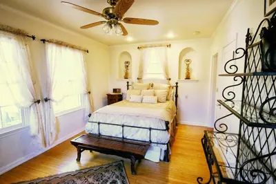 a bedroom with a bed and a ceiling fan at The Patrician Hollywood Universal in Pasadena