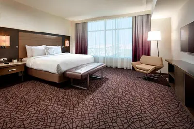 a hotel room with a bed and a chair at Residence Inn by Marriott at Anaheim Resort/Convention Center in Anaheim