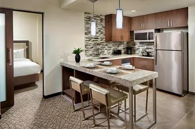 a kitchen with a kitchen island with a refrigerator at Residence Inn by Marriott at Anaheim Resort/Convention Center in Anaheim