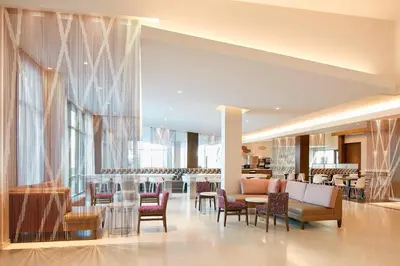 a lobby with chairs and tables in a building at Residence Inn by Marriott at Anaheim Resort/Convention Center in Anaheim