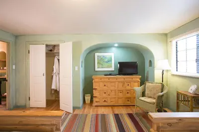 a living room with a tv on a wooden dresser at Blue Iguana Inn in Ojai