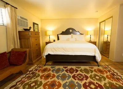 a bedroom with a large bed and a couch at Blue Iguana Inn in Ojai