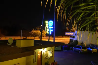 a gas station with a neon sign at night at Bayshore Inn Ventura in Ventura