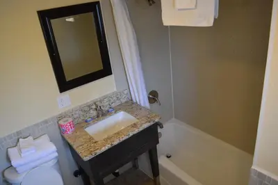 a bathroom with a sink and a toilet and a tub at Bayshore Inn Ventura in Ventura