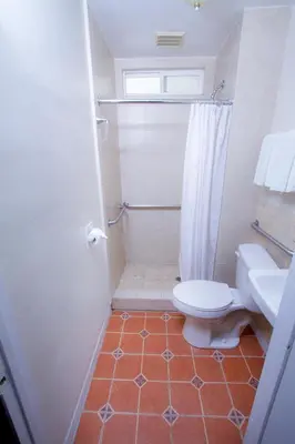 a bathroom with a toilet and a shower at Mission Bell Motel in Ventura