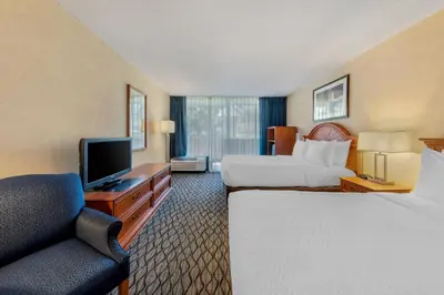 a hotel room with two beds and a television at Clarion Hotel Anaheim Resort in Anaheim