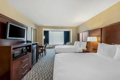 a hotel room with two beds and a flat screen tv at Clarion Hotel Anaheim Resort in Anaheim