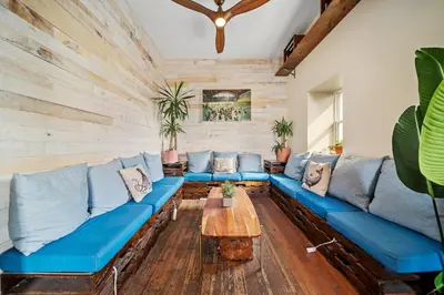 a living room with a blue couch and a table at Samesun Venice Beach Hotel & Hostel in Los Angeles