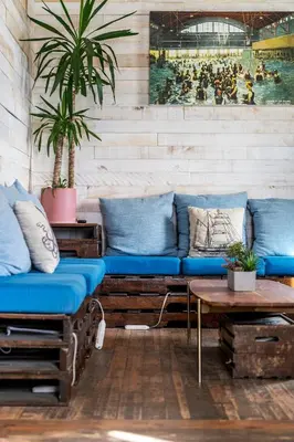 a living room with a blue couch and a table at Samesun Venice Beach Hotel & Hostel in Los Angeles