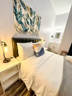 a bedroom with a large white bed with a headboard at Samesun Venice Beach Hotel & Hostel in Los Angeles