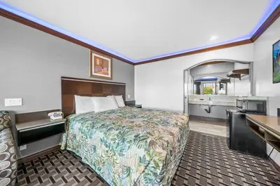 a hotel room with a bed and a sink at Starlight Inn South El Monte in South El Monte