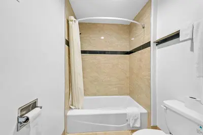 a bathroom with a tub and a toilet and a sink at Starlight Inn South El Monte in South El Monte