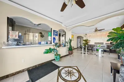 a lobby of a store with a counter and tables at Starlight Inn South El Monte in South El Monte
