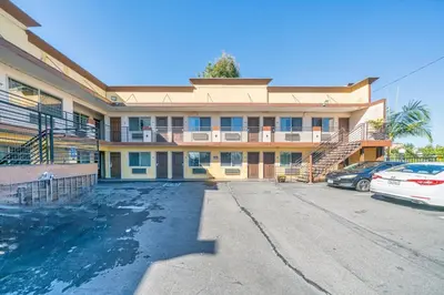 a building with a car parked in front of it at Starlight Inn South El Monte in South El Monte