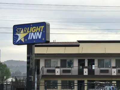 a sign for a straight inn in front of a building at Starlight Inn South El Monte in South El Monte