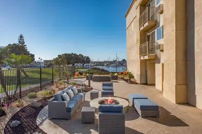 a patio with couches and a fire pit in front of a building at Hampton Inn Channel Islands Harbor in Oxnard
