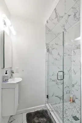 a white bathroom with a shower and a sink at 4 bedroom and 3 bath home close to universal studio and Hollywood in Sherman Oaks