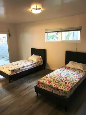 a bedroom with two beds and a window at 4 bedroom and 3 bath home close to universal studio and Hollywood in Sherman Oaks