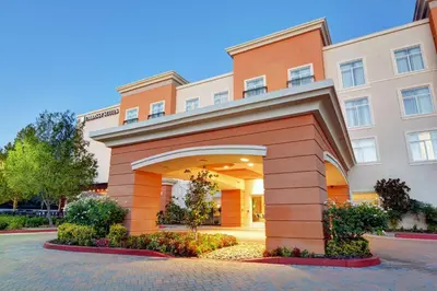 a large building with an arch in front of it at Embassy Suites Valencia in Valencia