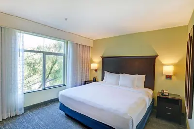 a hotel room with a bed and a large window at Embassy Suites Valencia in Valencia