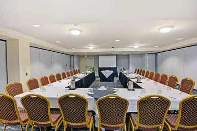 a conference room with a long table and chairs at Embassy Suites Valencia in Valencia