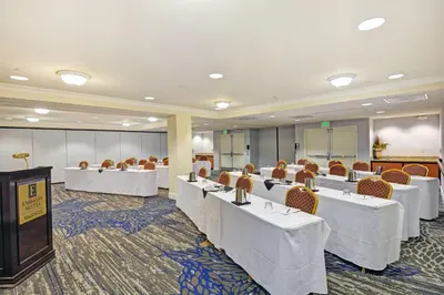 a conference room with white tables and chairs at Embassy Suites Valencia in Valencia