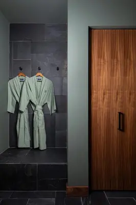 two suits are hanging on a wall next to a door at Hotel Marina Riviera in Big Bear Lake