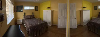 a bedroom with two beds and yellow walls at Beautiful Foothill Home in Rancho Cucamonga