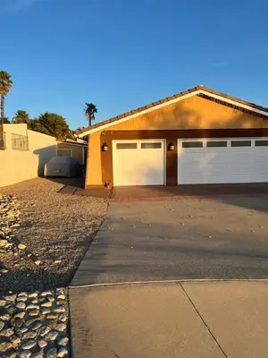 a house with two garage doors and a driveway at Beautiful Foothill Home in Rancho Cucamonga