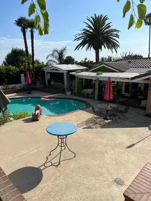 a patio with a table and chairs and a pool at Beautiful Foothill Home in Rancho Cucamonga