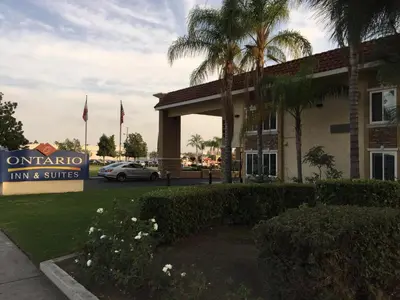 a hotel with a sign in front of a building at Ontario Inn & Suites in Montclair
