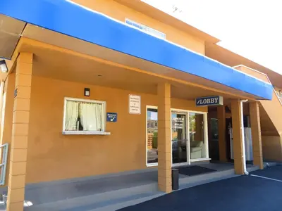 a building with a sign that reads motel at American Inn in Ontario