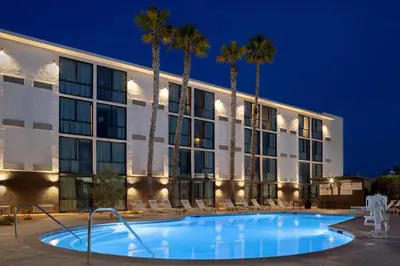 a pool in front of a hotel at night at Doubletree By Hilton Palmdale, Ca in Palmdale