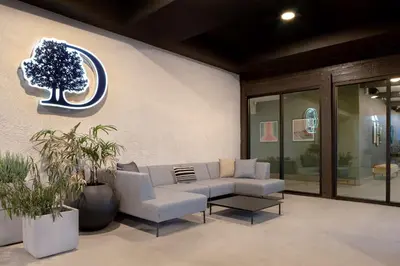 a lobby with a couch and a tree on the wall at Doubletree By Hilton Palmdale, Ca in Palmdale