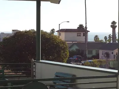 a view of a street with a building in the background at Travelers Beach Inn in Ventura