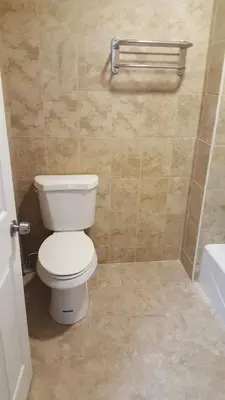 a bathroom with a toilet and a bath tub at Flamingo Inn Long Beach in Long Beach
