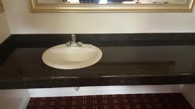 a white sink in a black counter in a bathroom at Flamingo Inn Long Beach in Long Beach